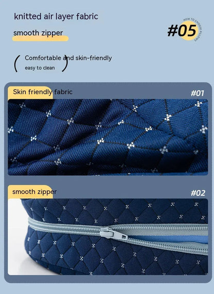 Dark blue jacquard heart-shaped memory foam leg pillow for adults on a bed.