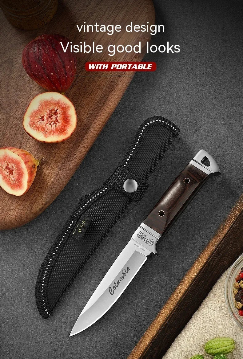 Camping fruit knife with stainless steel blade and brown leather sheath on a wooden surface
