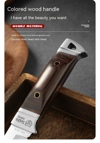 Camping fruit knife with stainless steel blade and brown leather sheath on a wooden surface