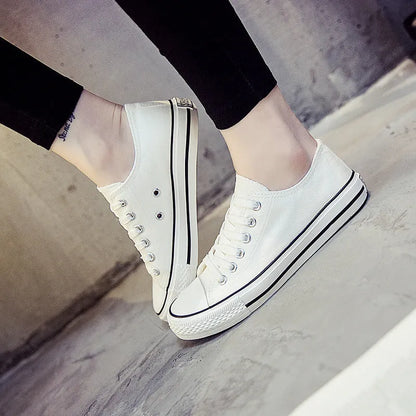 Women's low-top canvas shoes in solid colours on a plain background, showing rubber sole and classic casual style.