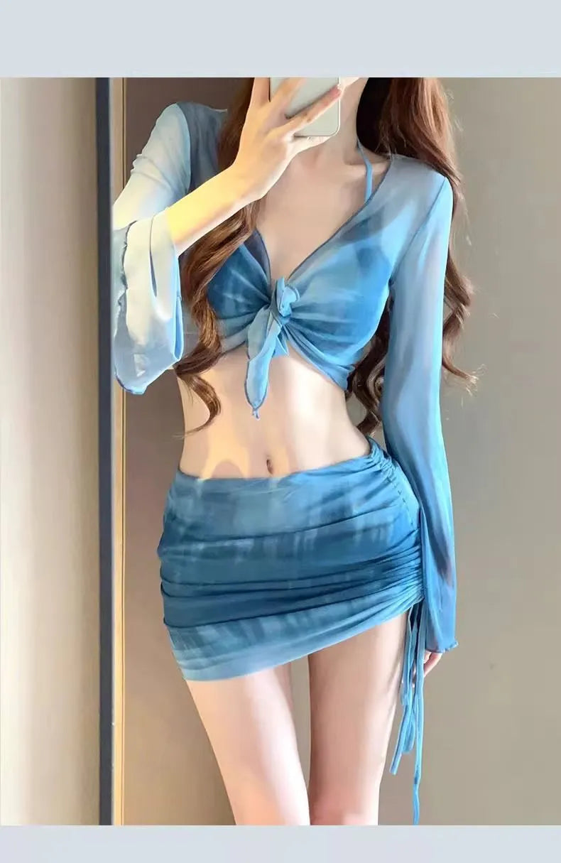 Women's blue high-waisted bikini four-piece set showing shirt, bra, underwear, and skirt pieces