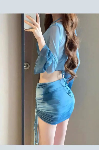Women's blue high-waisted bikini four-piece set showing shirt, bra, underwear, and skirt pieces