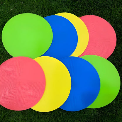 Soft yellow TPE football landmark pad disc on grass, 23 cm diameter.