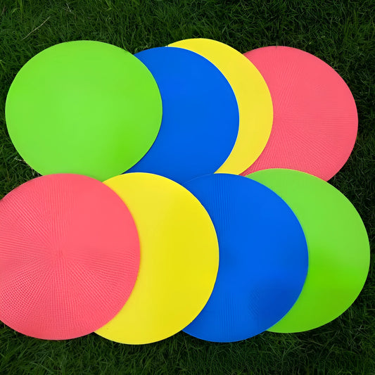 Soft yellow TPE football landmark pad disc on grass, 23 cm diameter.