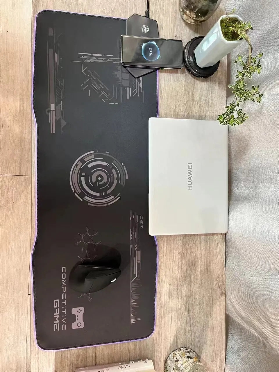 Black luminous gaming mouse mat with mech style graphics, water-repellent cloth surface, and USB cable
