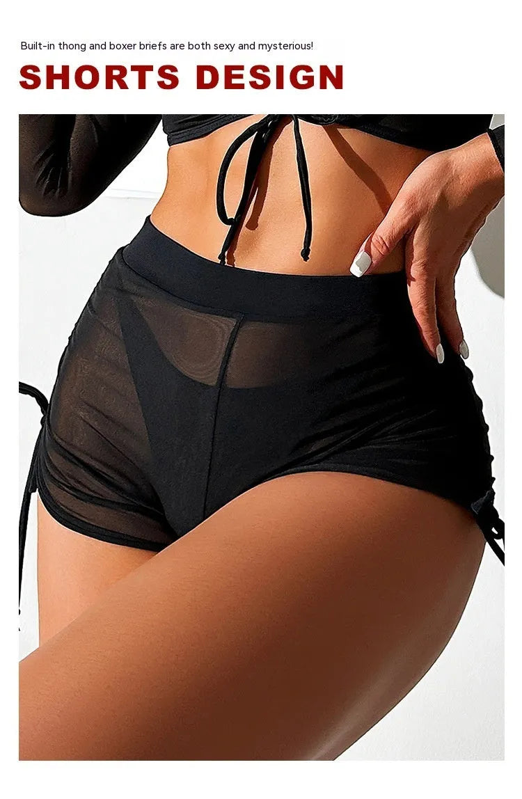 Black mesh long sleeve women's bikini four-piece swimsuit set on a white background.