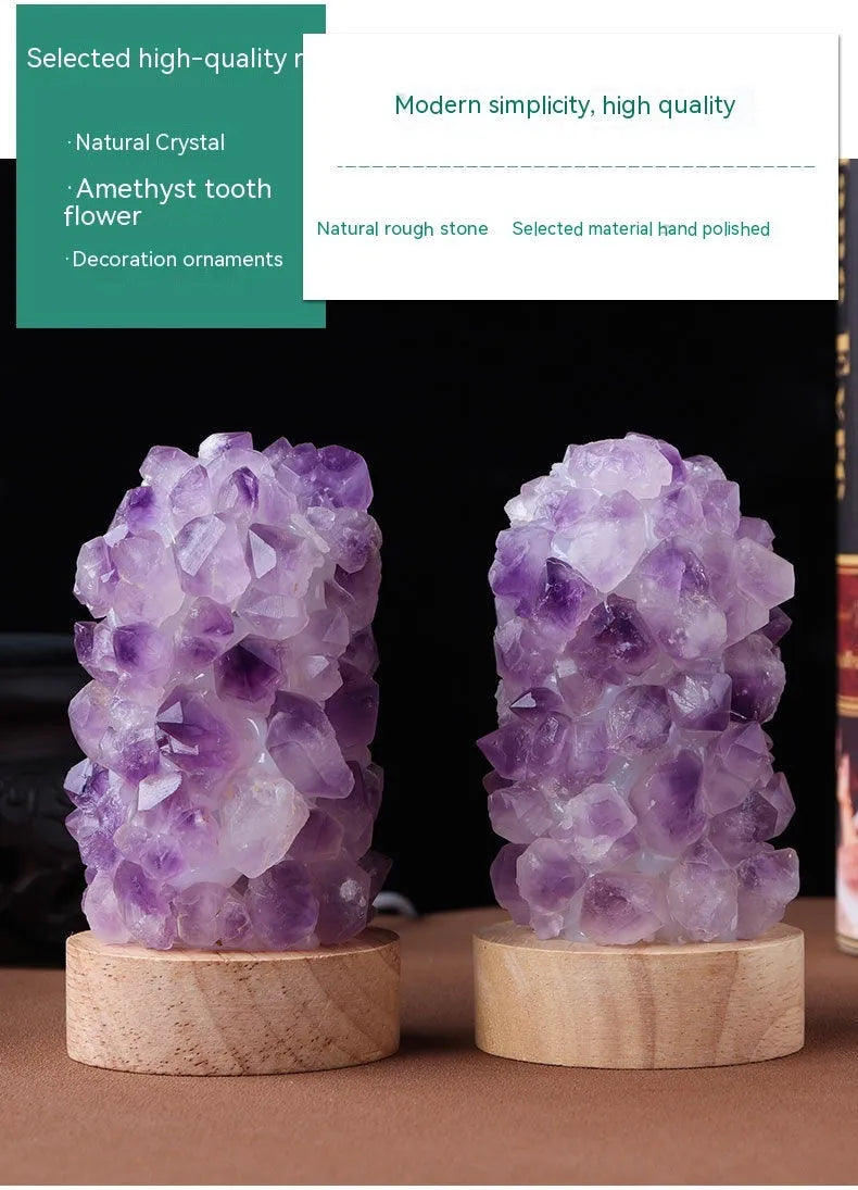 Miniature amethyst crystal tooth flower night light glowing with warm light on a wooden surface.