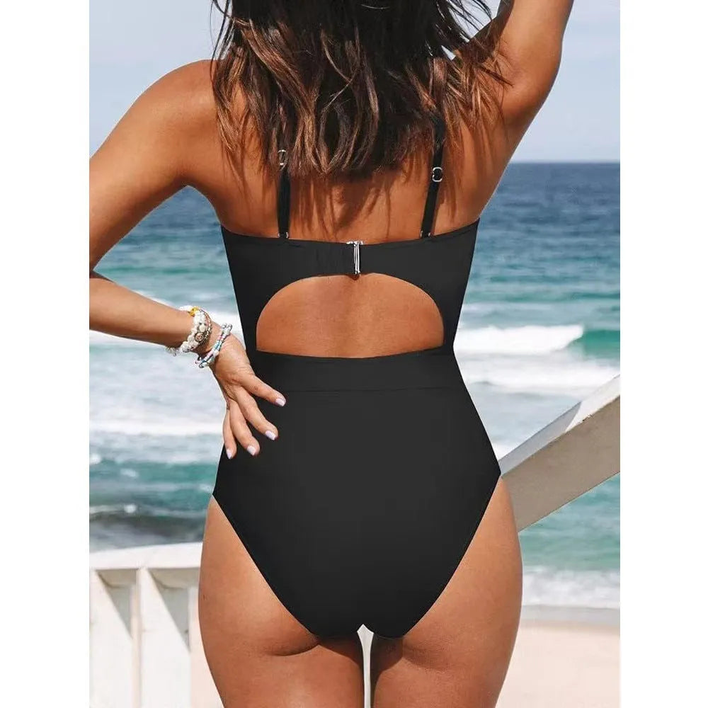 Black one-piece swimsuit on a model showing backless design