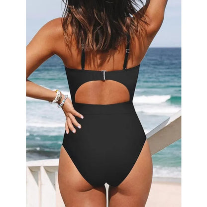 Black one-piece swimsuit on a model showing backless design