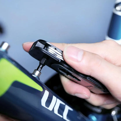 Compact, multi-function bicycle repair tool with wrench, tire spoon, and venting cap tools
