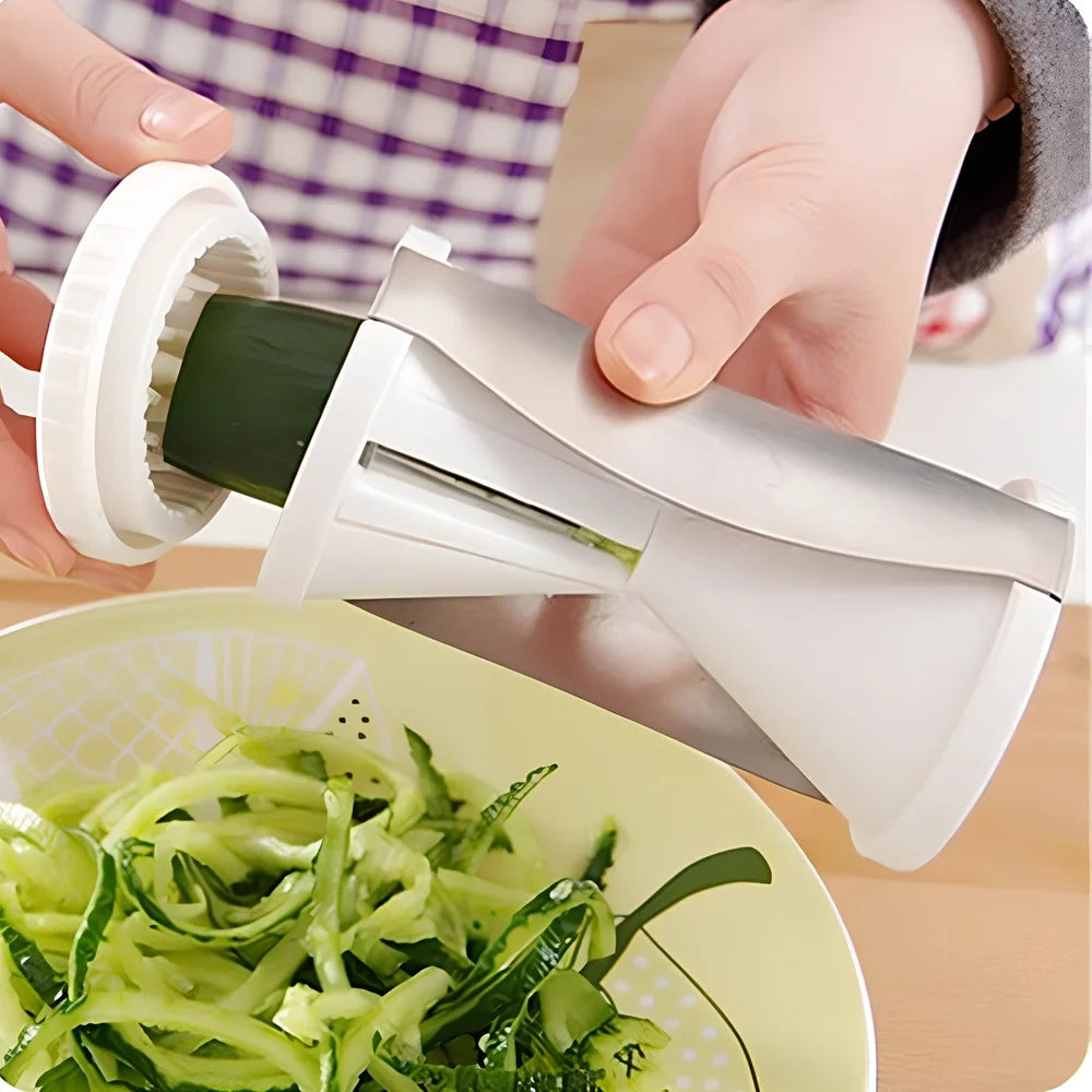 White spiral vegetable slicer with stainless steel blades on kitchen counter with zucchini noodles