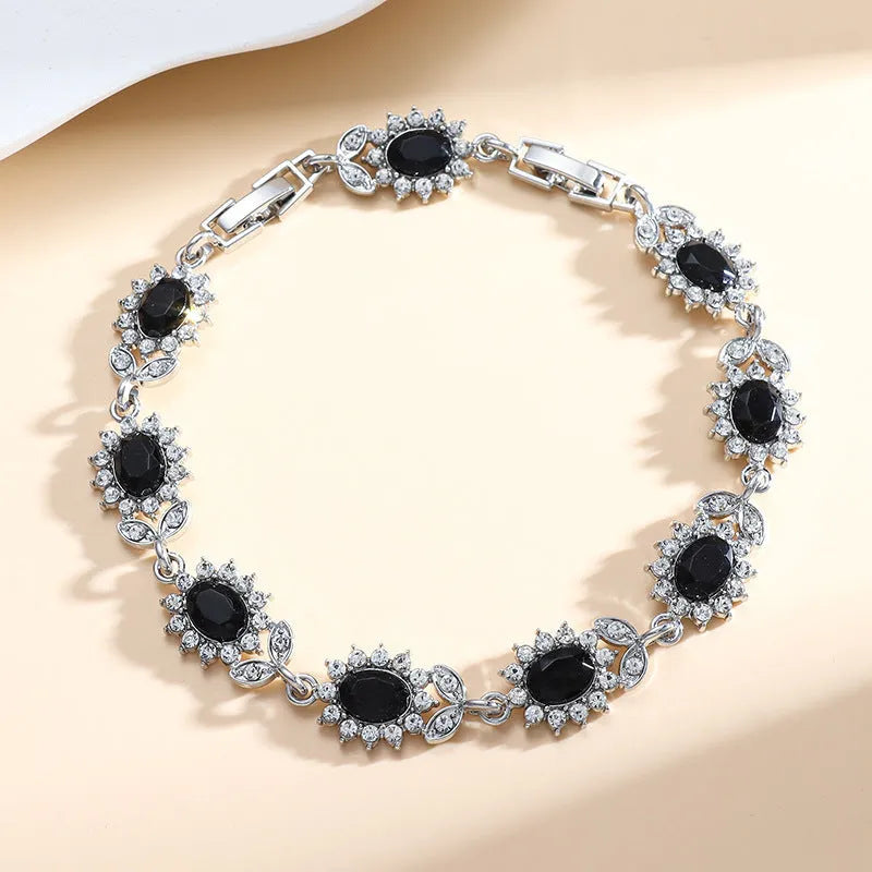 Personality Trend women's simple bracelet with inlaid zircon stones in a choice of nine gemstone colours on a wrist.