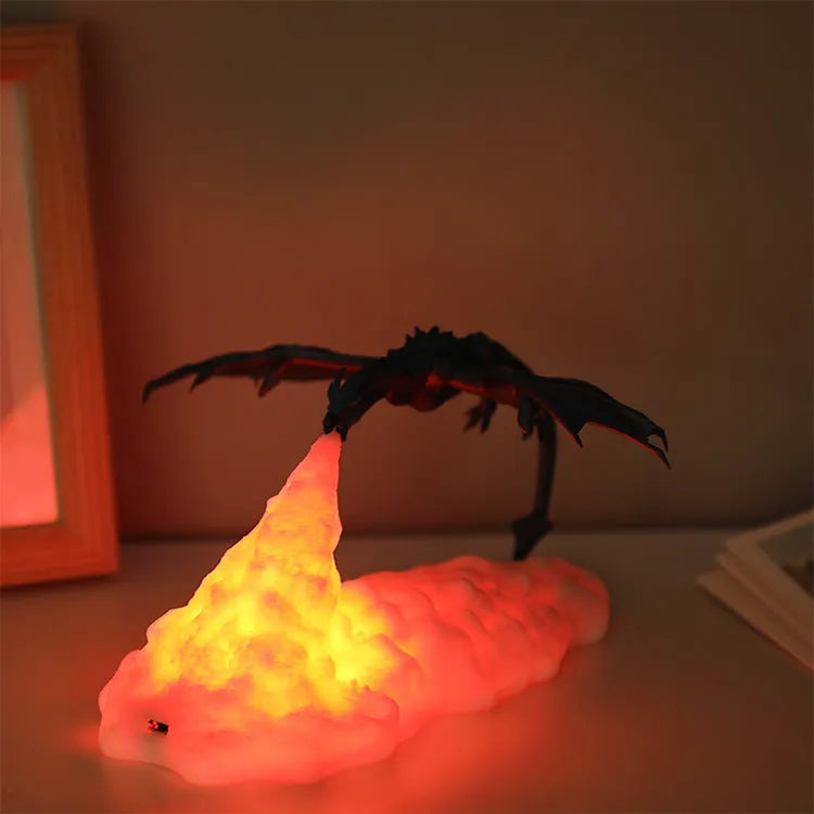 3D printed fire-breathing dragon night light with warm red LED illumination on dark surface