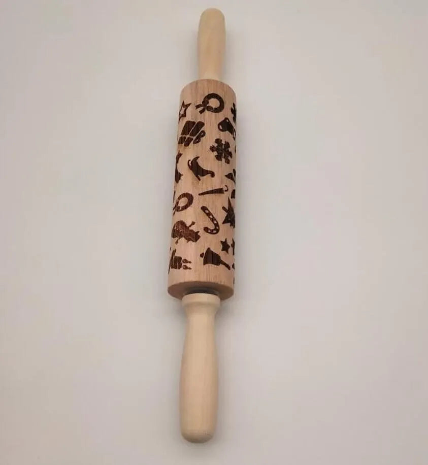 Wooden rolling pin with engraved Christmas patterns including reindeer and snowflakes on a 45cm long barrel.