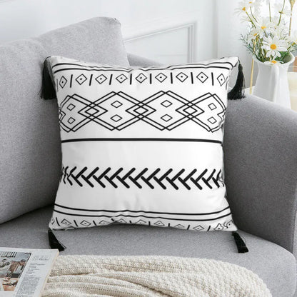 Bohemian style decorative pillowcase in light grey colour on a sofa.