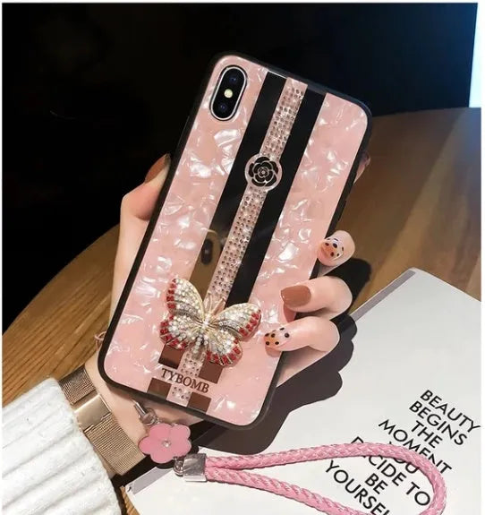 Clear acrylic iPhone case with Swarovski crystal butterfly design and central mirror in purple.
