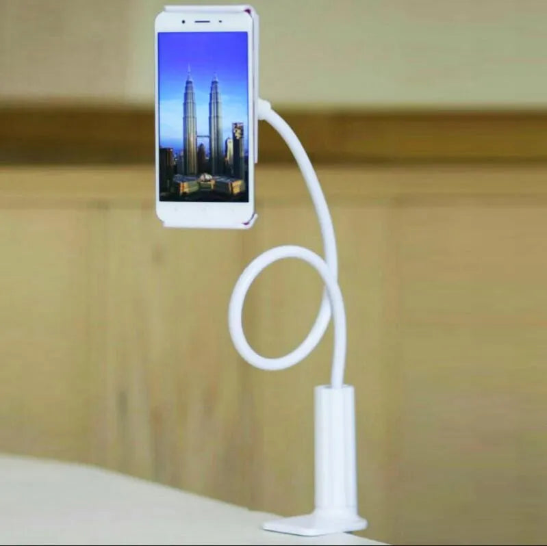 Bedside oversize flat panel handset with long arm holding a mobile phone on a table