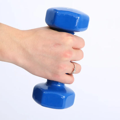 A pair of brightly coloured plastic fitness dumbbells with a glossy surface, shown on a home floor.