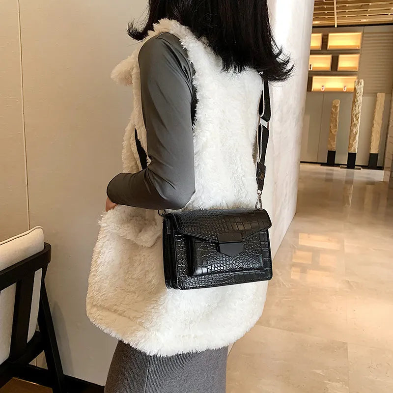 Vintage crossbody bag in black showing 20cm width, crossbody strap, and front storage compartment