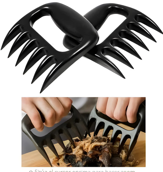 Two black bear claw meat shredders with decorative handles on a kitchen surface.