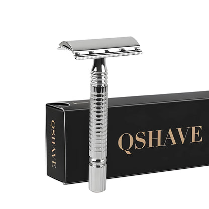 Chrome-plated double-edged safety razor with textured brass handle and storage box.