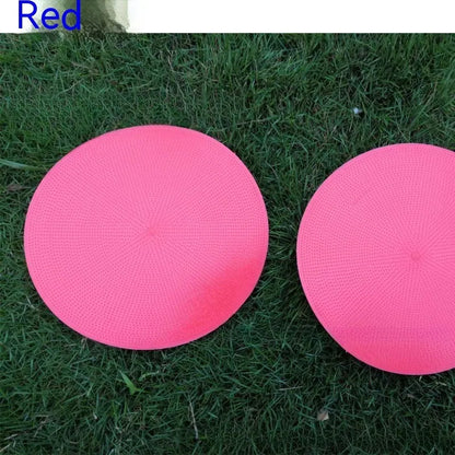 Soft yellow TPE football landmark pad disc on grass, 23 cm diameter.