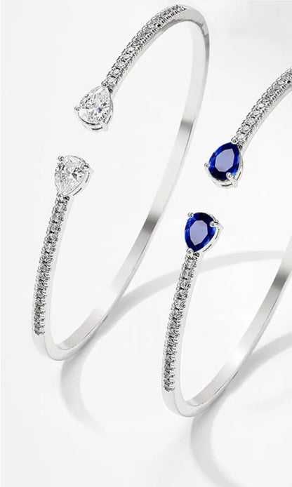 Close-up of a multi-zircon inlay fashion bracelet in copper, shown in blue and white colour options.