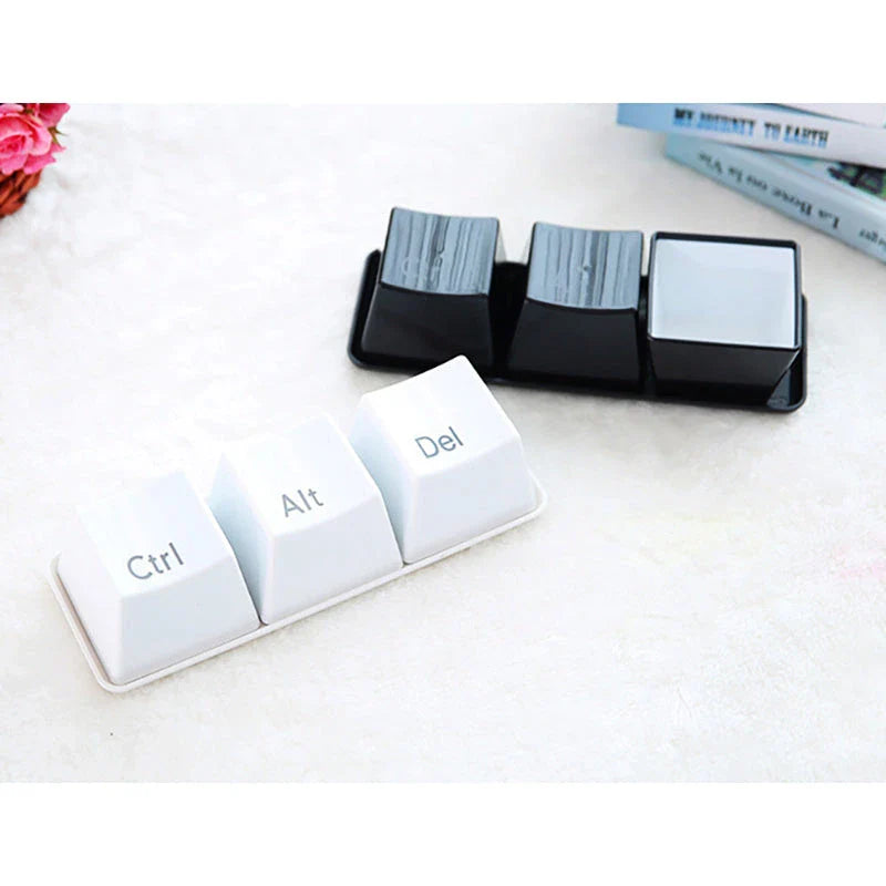 A set of three keyboard-inspired beverage cups with an attached tray, providing a unique and stylish desk accessory.