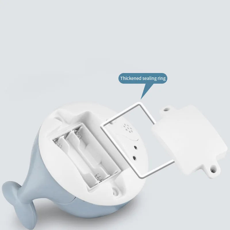 Automatic water-spraying whale bath toy with colourful lights floating in bath water.