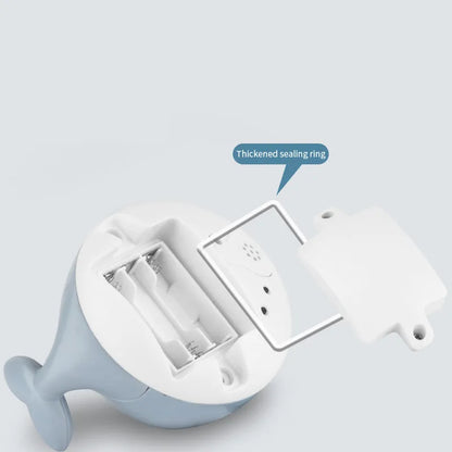 Automatic water-spraying whale bath toy with colourful lights floating in bath water.