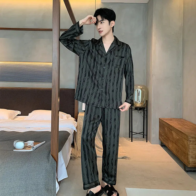 Black stripes men's ice silk pyjama set with V-neck top and long trousers on a hanger.