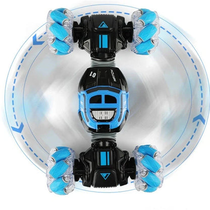 Red 4WD RC stunt car performing sideways drift with LED lights illuminated, showing gesture remote control