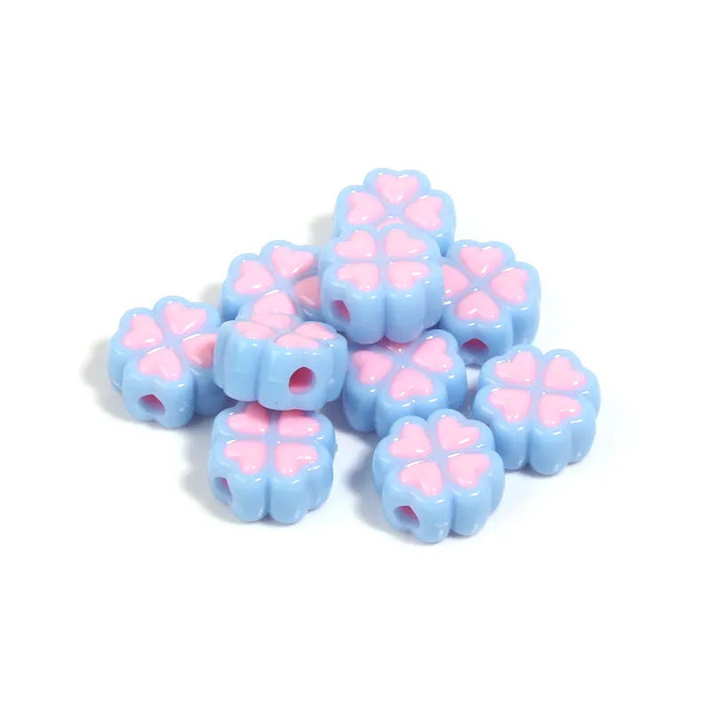 Assorted frosted acrylic four-leaf clover shaped beads in pink, green, and yellow, 15mm diameter.