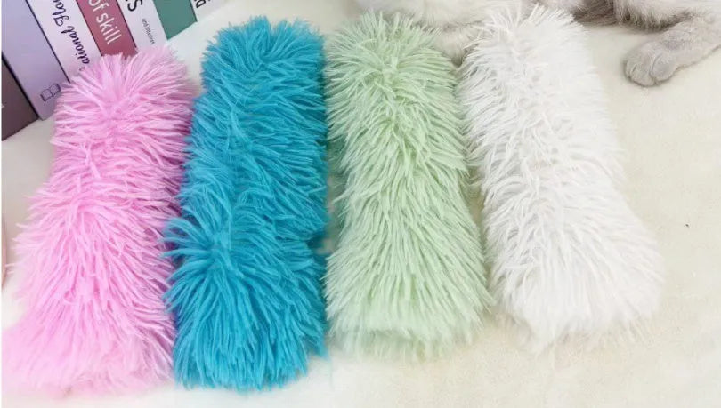 Plush cat toy pillow in blue, green, pink, and white colours measuring 27 by 10 centimetres