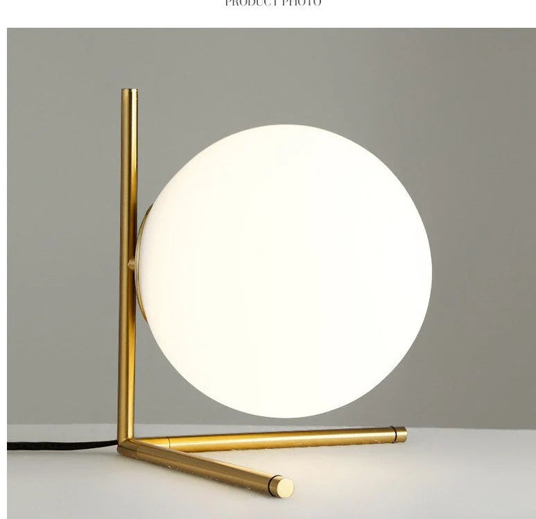 Clear glass spherical table lamp with aluminium base showing dual-colour LED lighting options