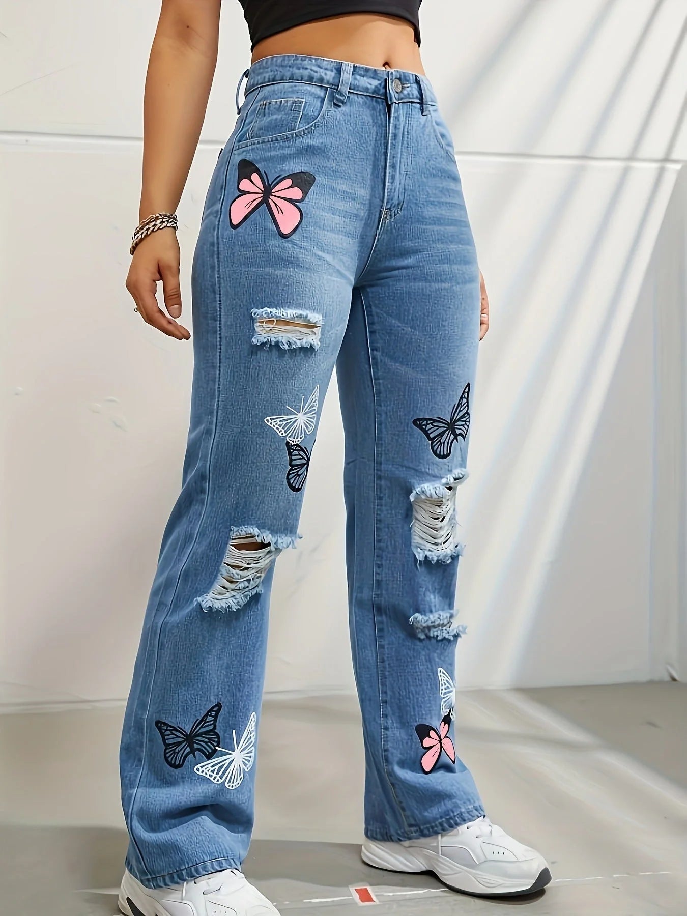 Women's high waisted straight leg jeans with butterfly print and distressed details