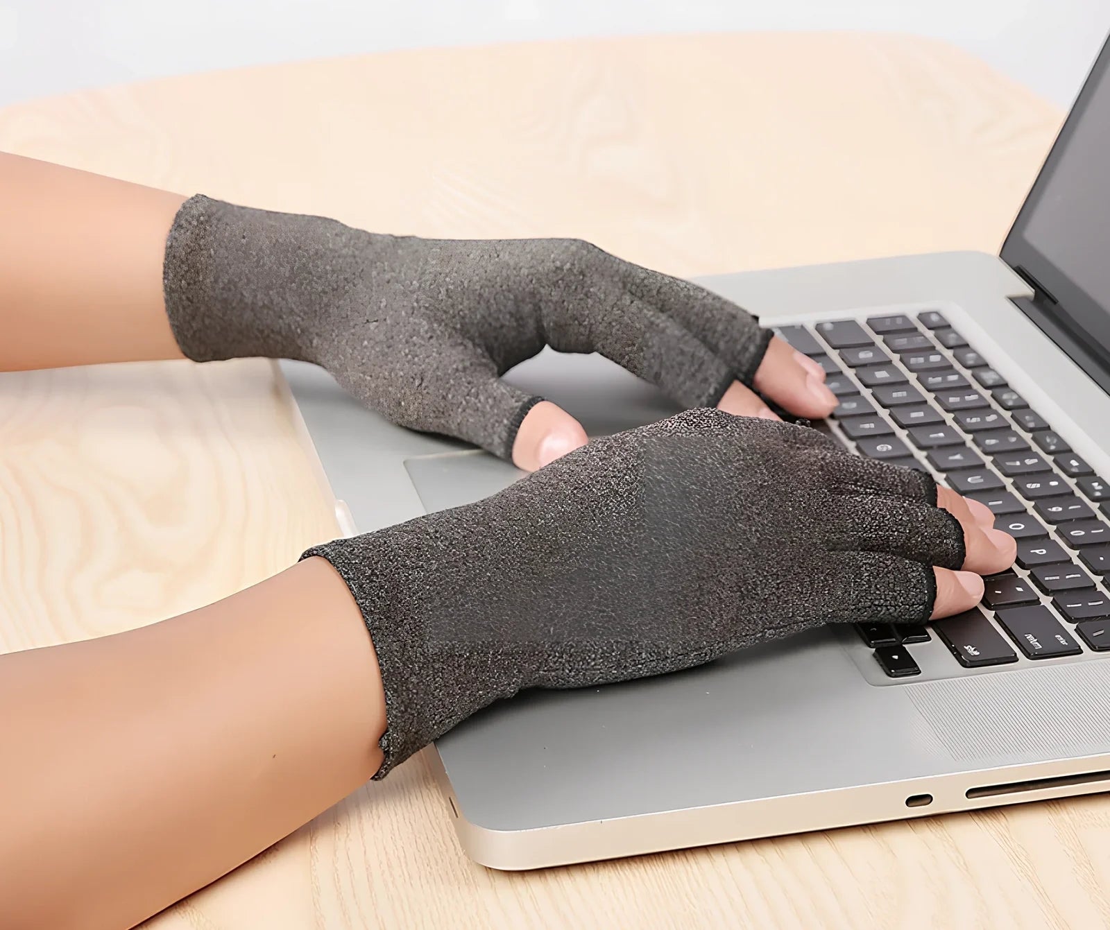 Breathable half-finger compression gloves showing exposed fingertips and adhesive grey section for joint support