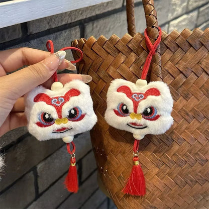 Blue and yellow Chinese style plush lion keychain ornament with star stone eyes and tassel.