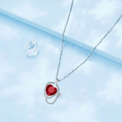 Red diamond wings cross stethoscope pendant necklace on a copper chain.