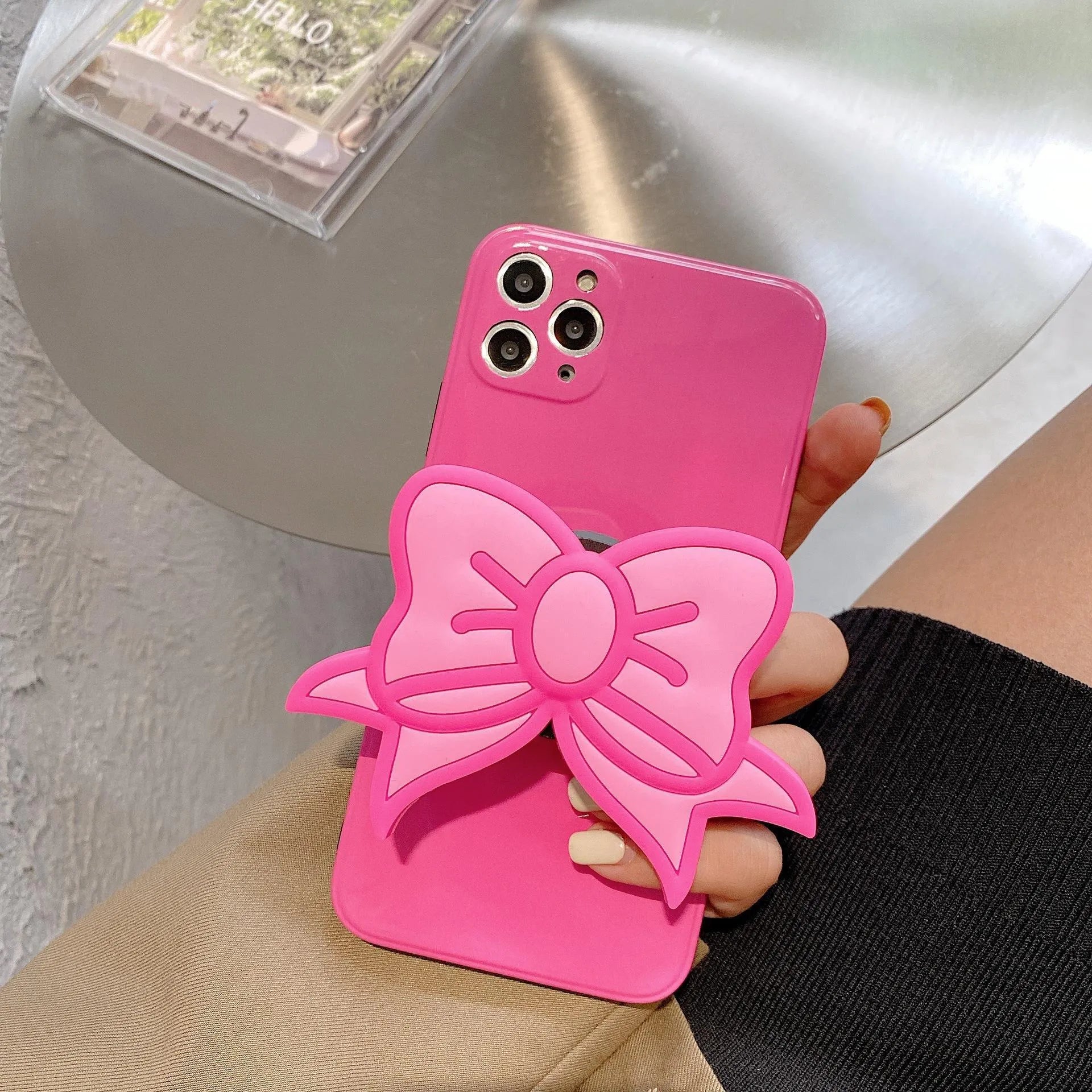 Rose red TPU iPhone case with integrated bow-shaped viewing stand
