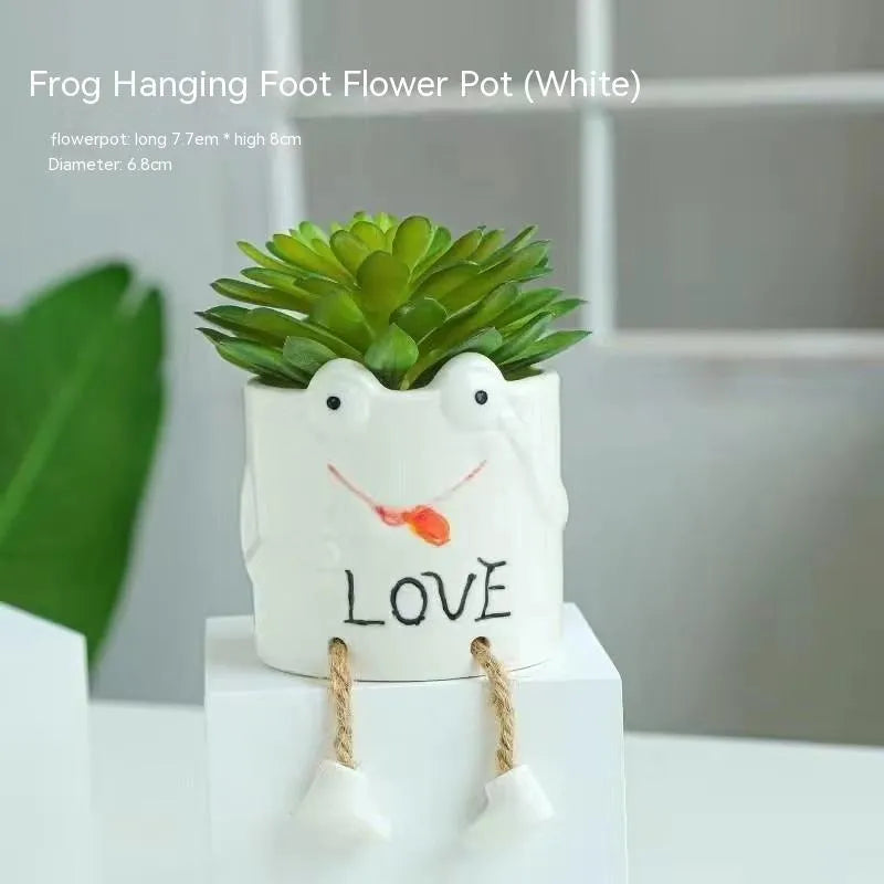 Ceramic hanging foot flowerpot for succulent plants with cartoon styling on desktop