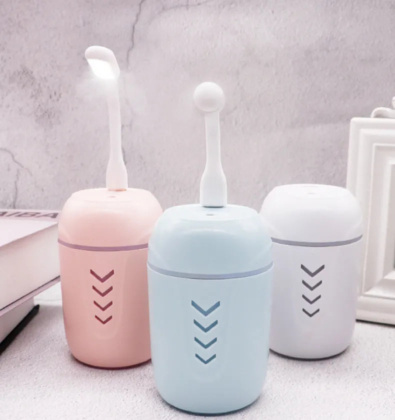 Portable humidifier for car or personal use with USB power, 200ml water tank, columnar shape, and aromatherapy function. Available in blue, pink, or white colour options, this mechanical operation device provides a mist output for use via USB or AC power.