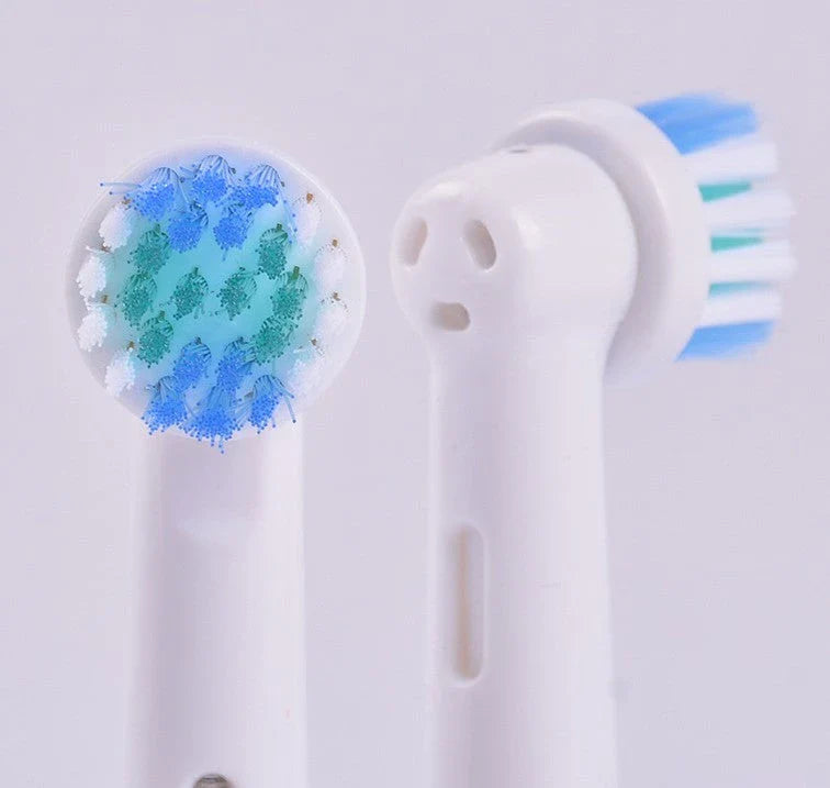 Premium electric toothbrush replacement heads in assorted colors, designed for universal fit with Oral-B and Braun electric toothbrushes.