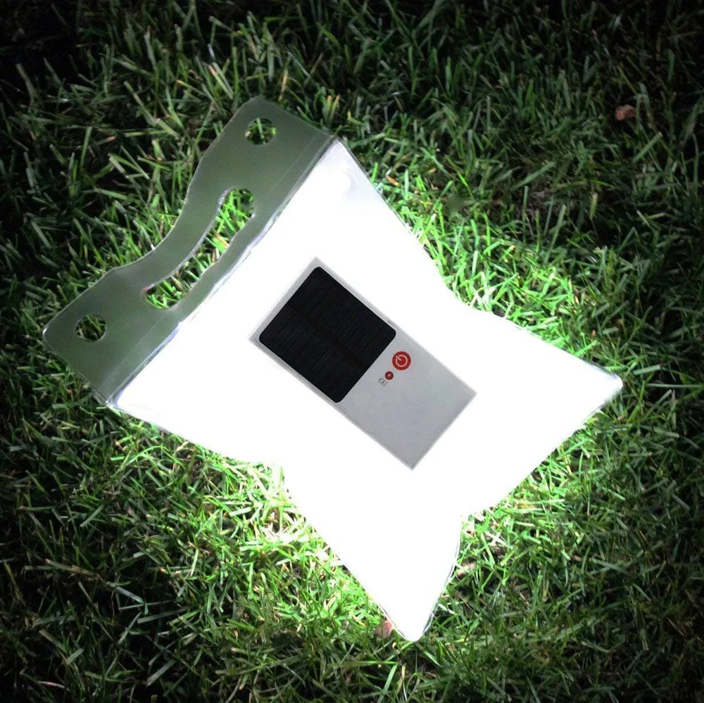 White solar inflatable LED camping light showing 310mm diameter when inflated with integrated solar panel
