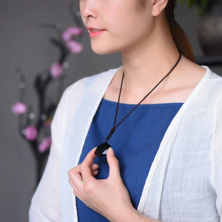 Handcrafted obsidian six-pointed star sweater chain pendant on a model