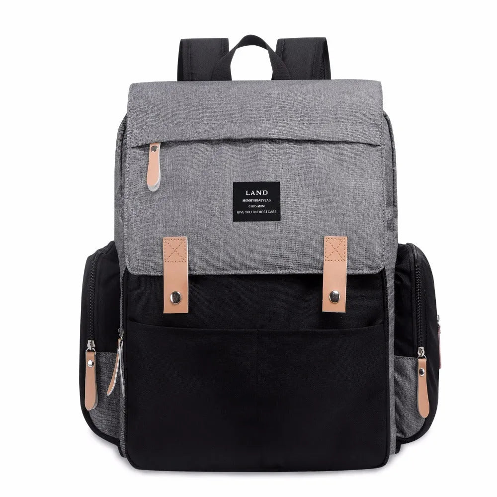 LAND Mommy large grey diaper backpack with changing mat, shown as a travel nappy bag.