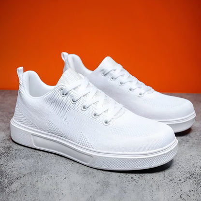 Pair of light white thick-soled casual sneakers with mesh upper and lace-up front.