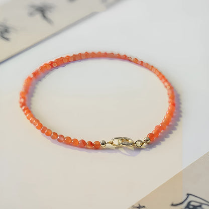 Close-up of a women's retro bracelet with a Southern Red Agate stone in cherry red on a wrist.