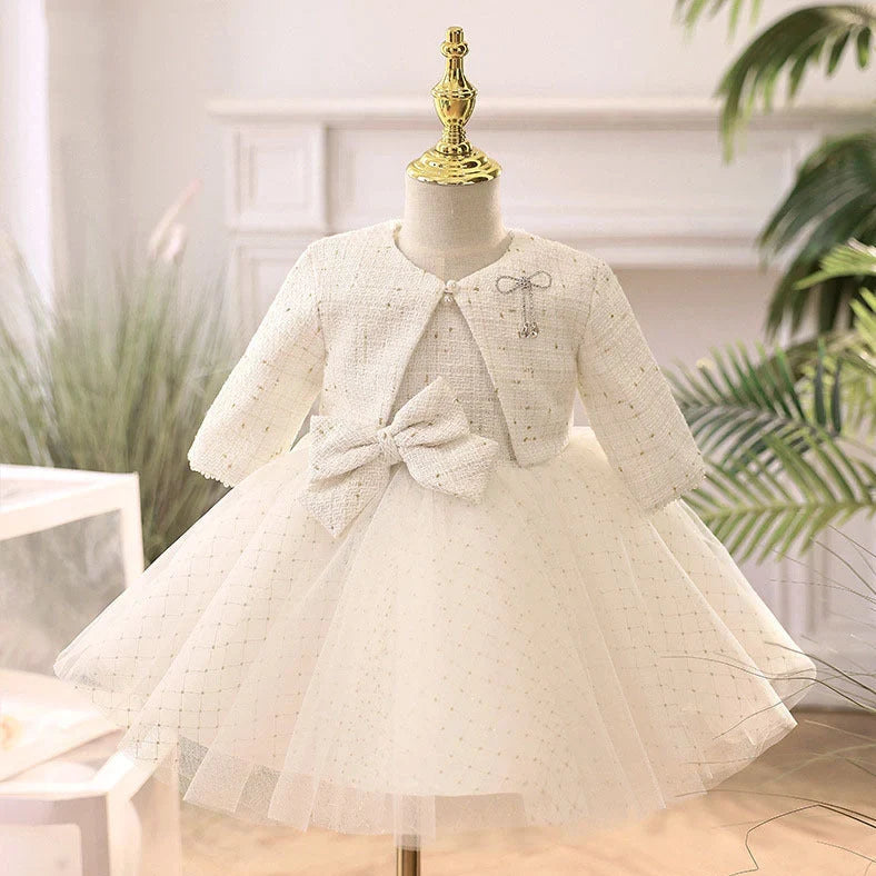 White long-sleeved flower girl wedding dress with princess styling on mannequin