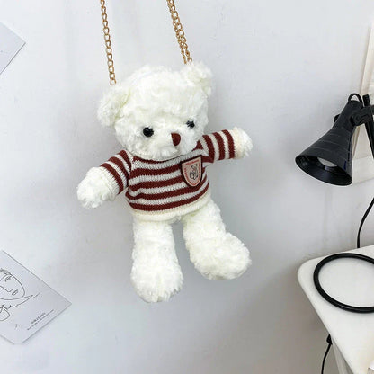 A plush teddy bear crossbody messenger bag with an adjustable shoulder strap and a zippered interior pocket for convenient storage.